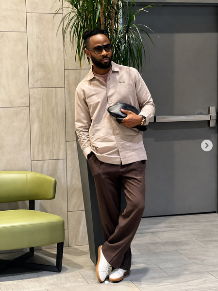 TNH model in a relaxed shirt and chocolate trousers